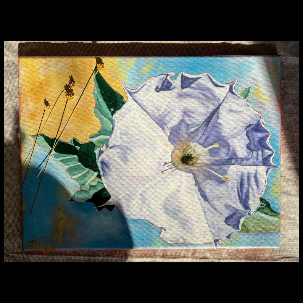 A square painting of a large white flower with blue shading, green leaves, and a yellow background, photographed against a neutral fabric backdrop.